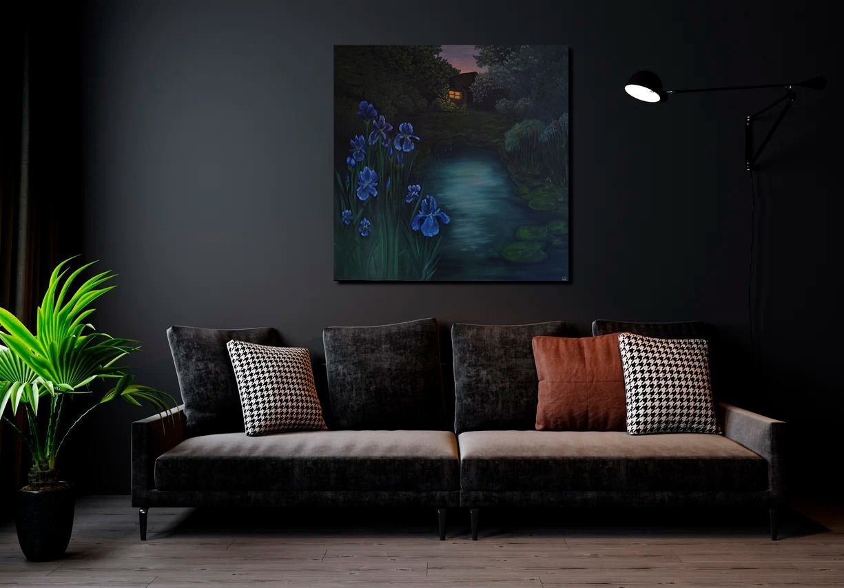 Dark living room with a sofa, cushions, and a painting on the wall.